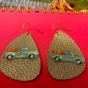 Silver metallic faux leather earrings with truck carrying pumpkins.